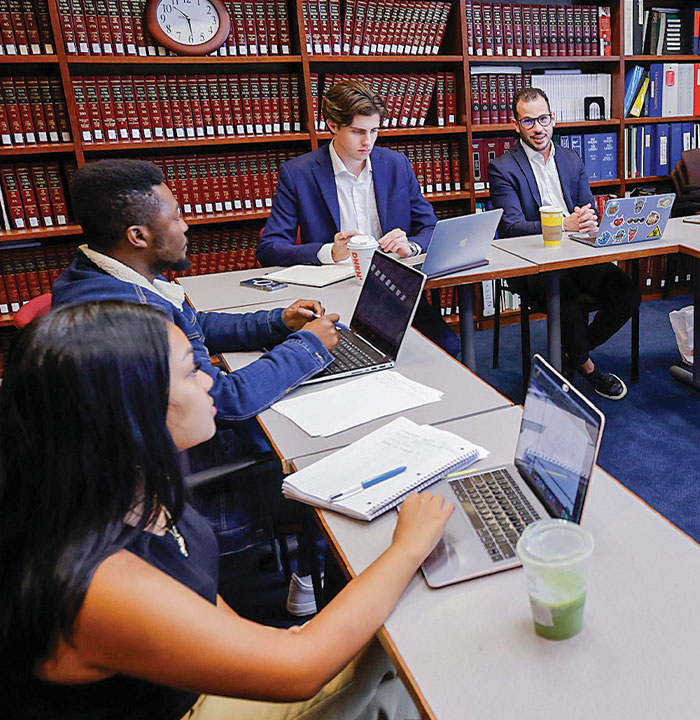 Three Law Students Working Together in the Moot Court Room