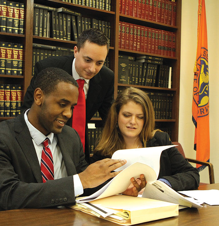 Three Law Students Studying at the Law Clinic