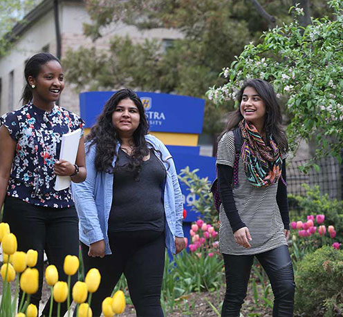 Three Students Walking on Campus